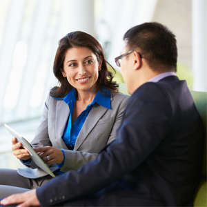Two colleagues sitting on a couch and talking
