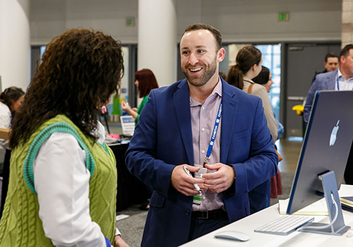 a man and a woman networking in exhibit hall