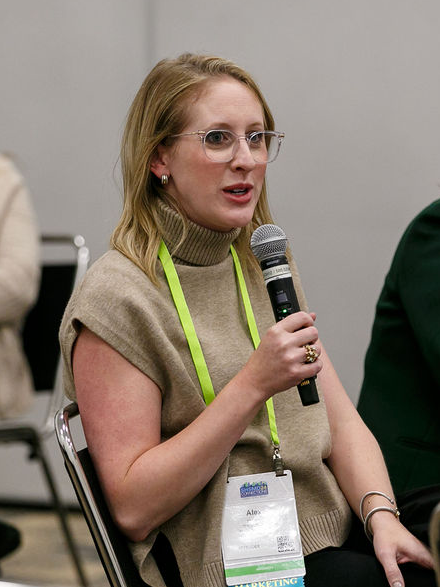 woman sitting speaking into microphone
